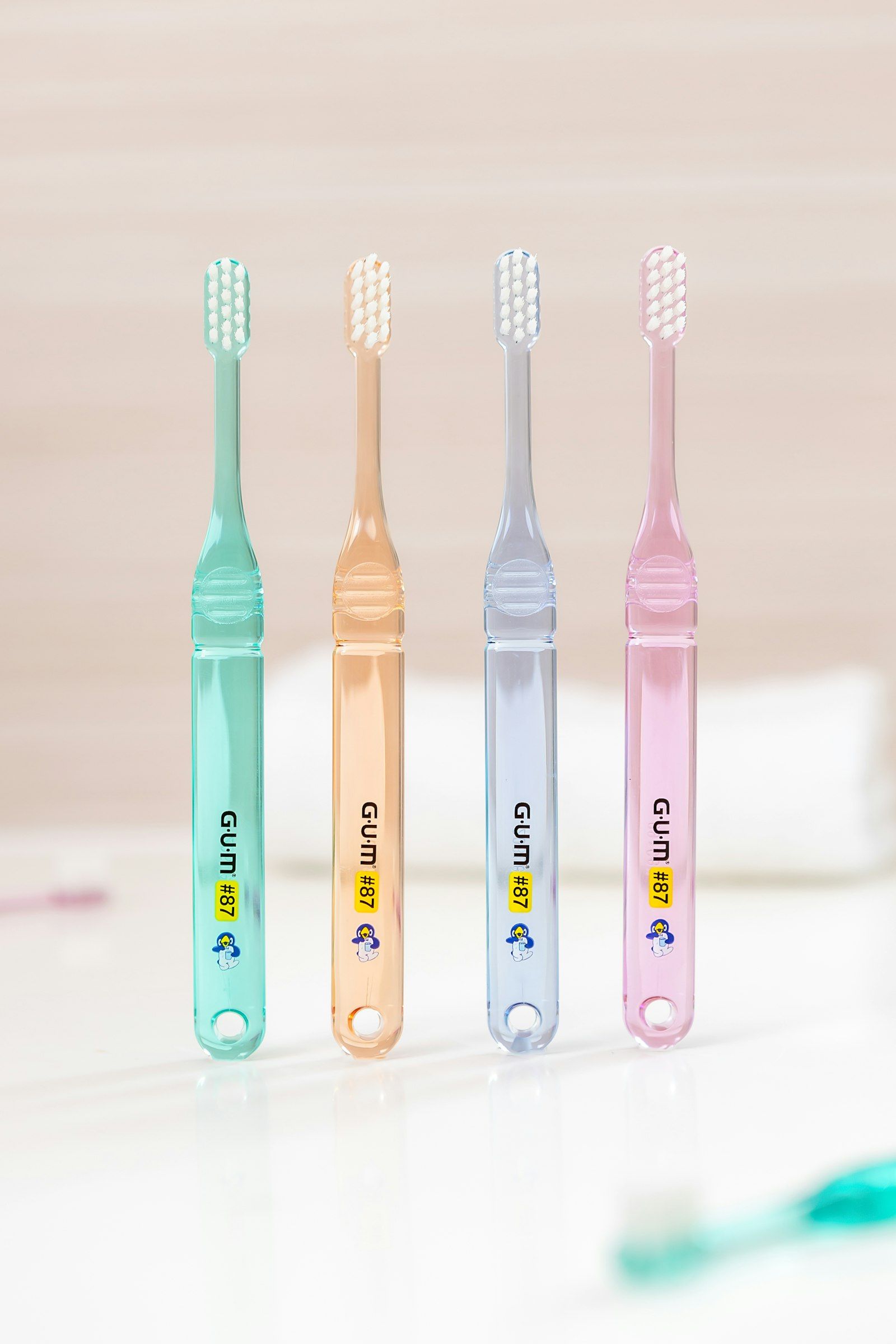 Cuatro cepillos de dientes pastel de pie, uno junto al otro.